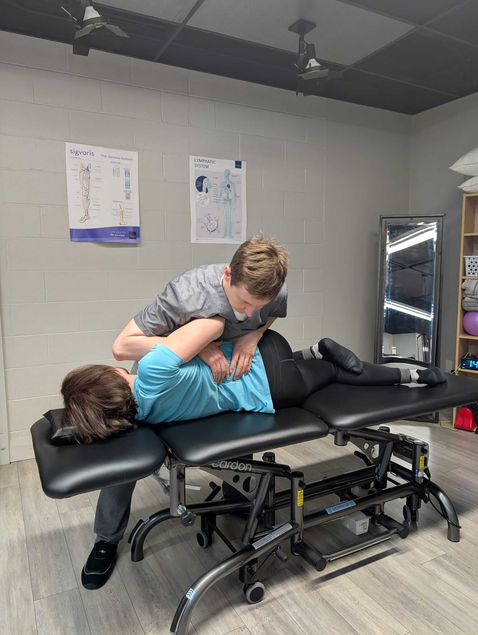Manual osteopath in Milton providing a lower back treatment to a patient for pain relief and mobility
